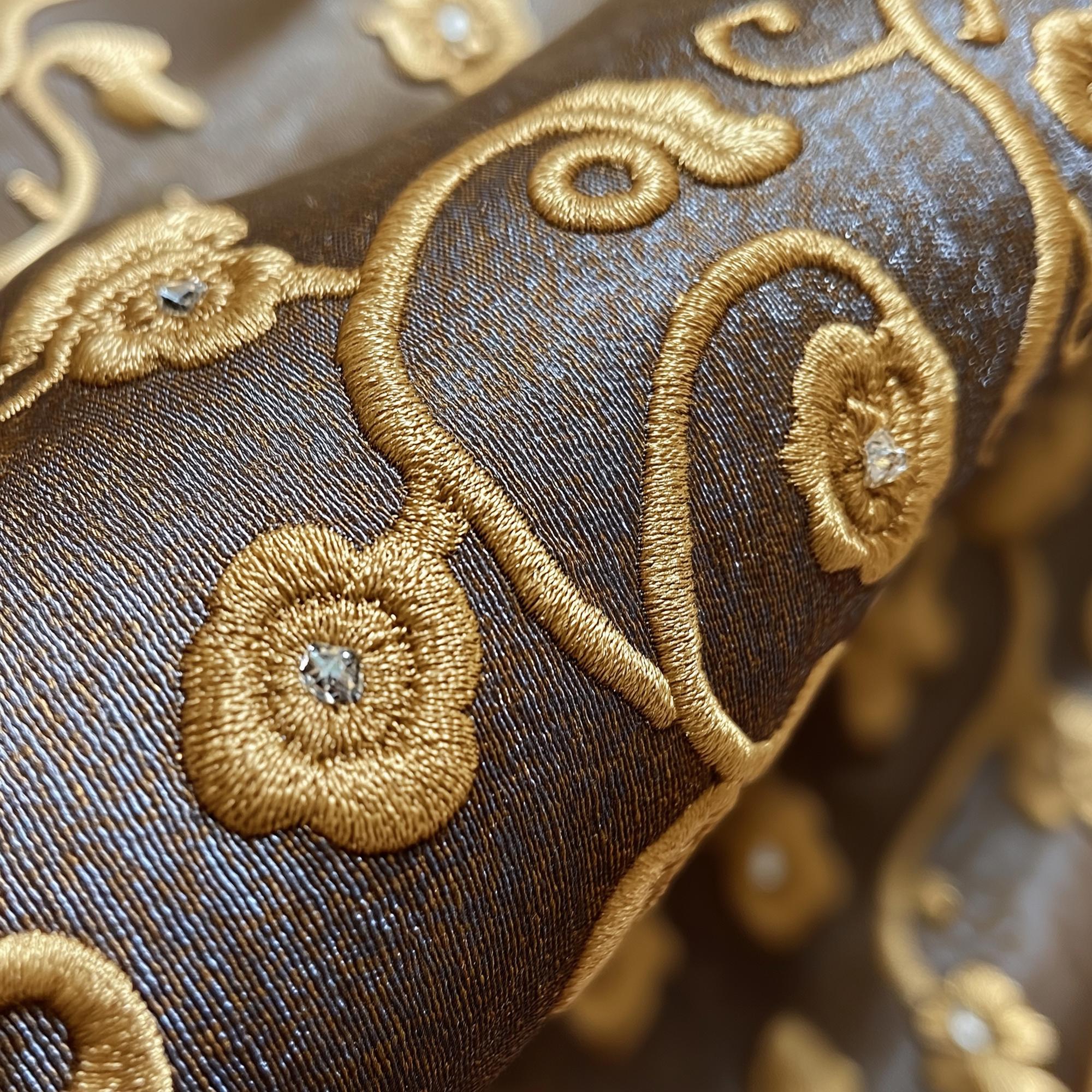 Close-up of luxury embroidered textile with gold thread